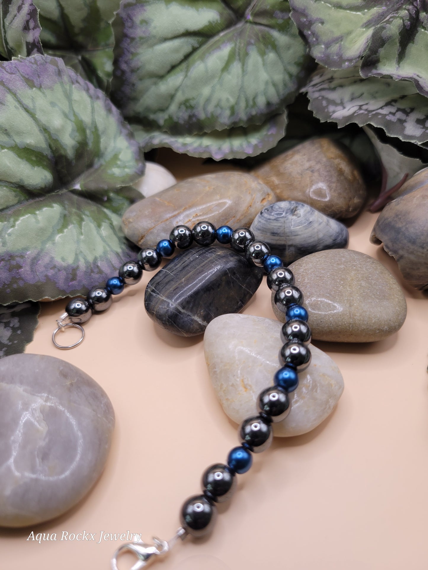 Silver and blue hematite bracelet with clasp.