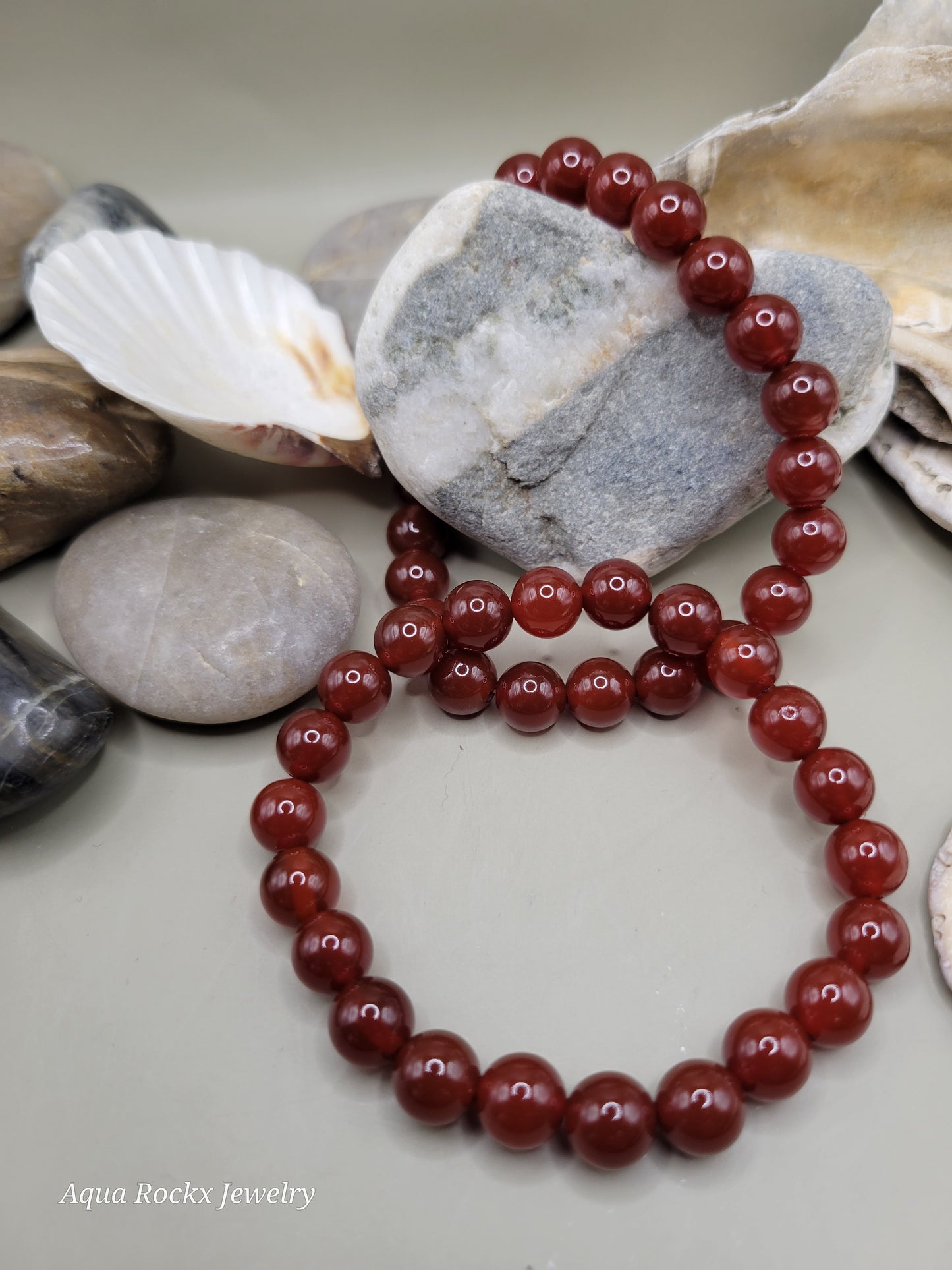 Orange beaded bracelet on a stone surface