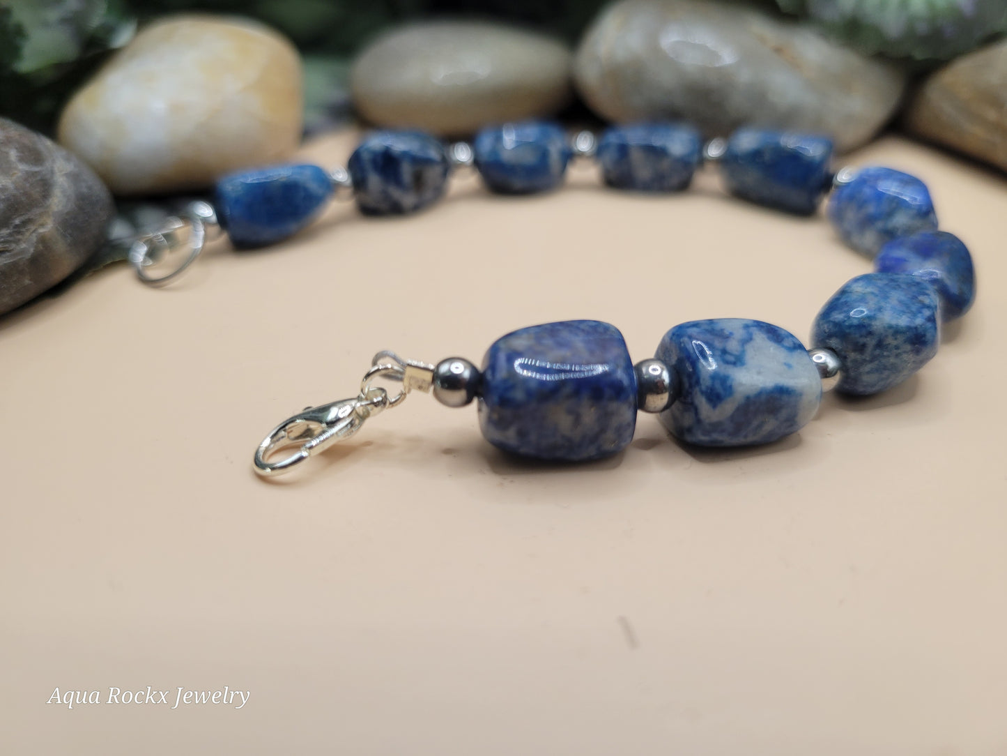 Sodalite Blue beaded bracelet with silver clasp on a neutral background