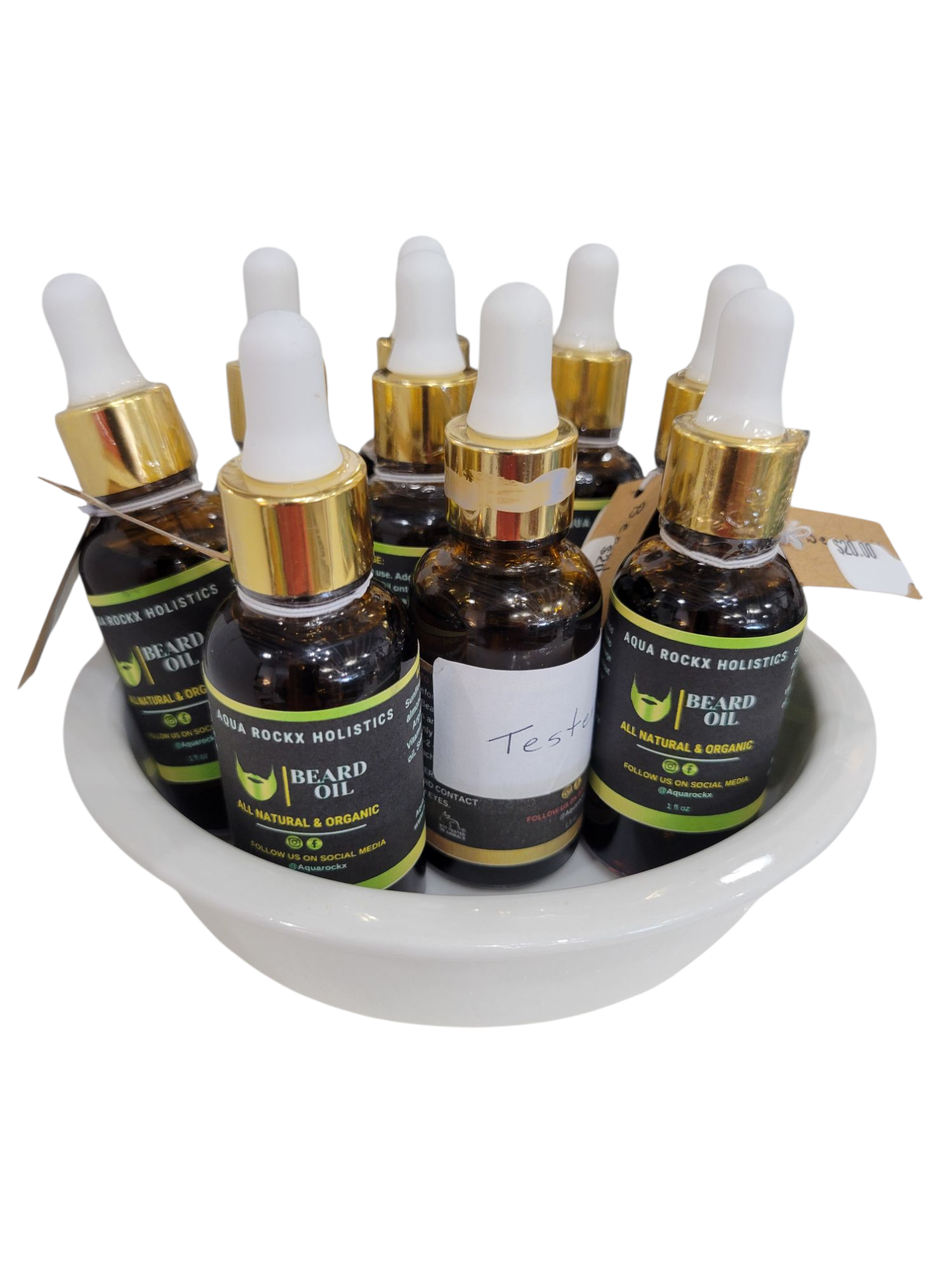 Set of beard oil bottles with droppers on a white dish