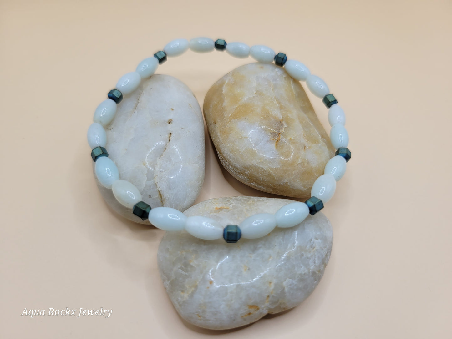 Beaded light green bracelet with green accents on stones, brand 'Aqua Rockx Jewelry' visible