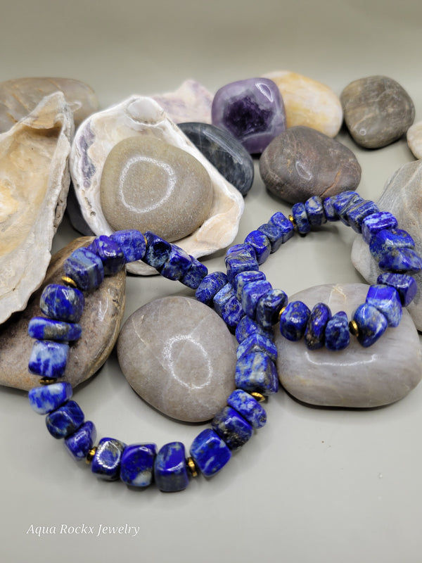 Blue beaded bracelet on a bed of stones and shells