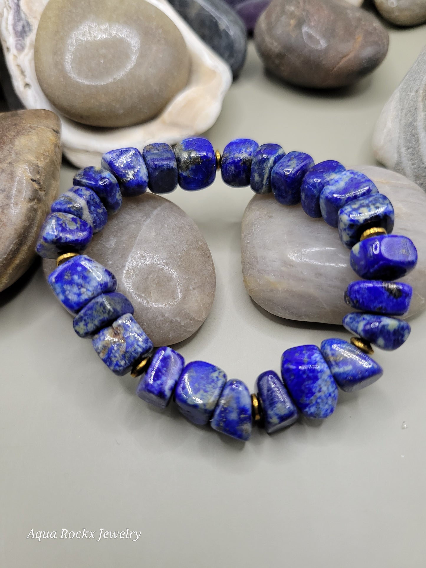 Lapis lazuli beaded bracelet on a stone surface