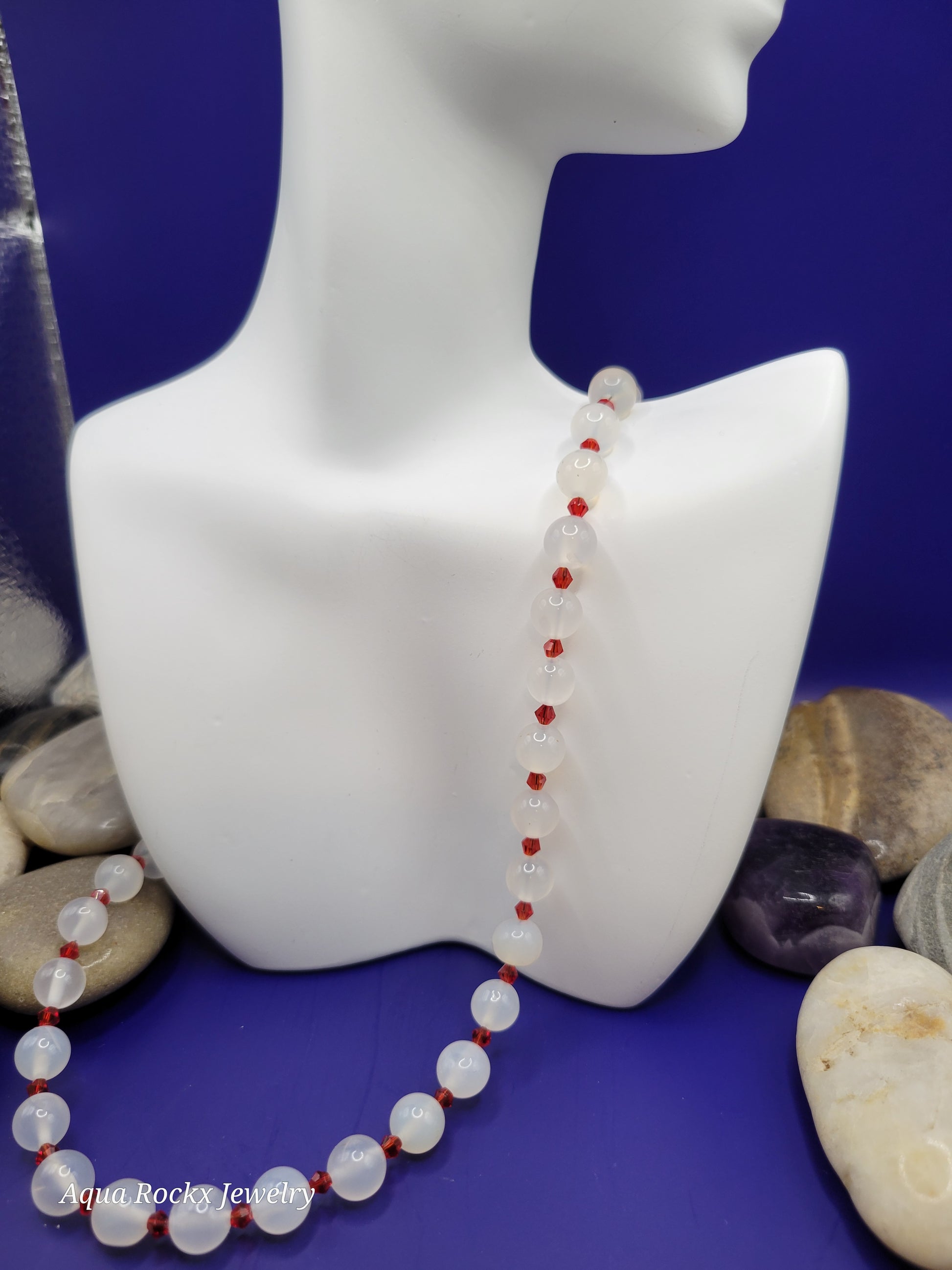 Red and white beaded necklace on a blue background