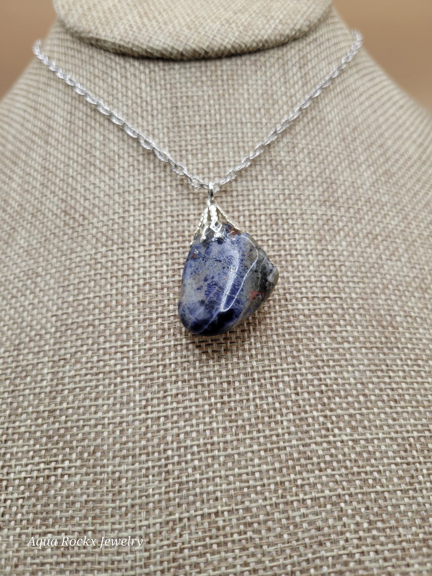Necklace with a pendant on a beige fabric background