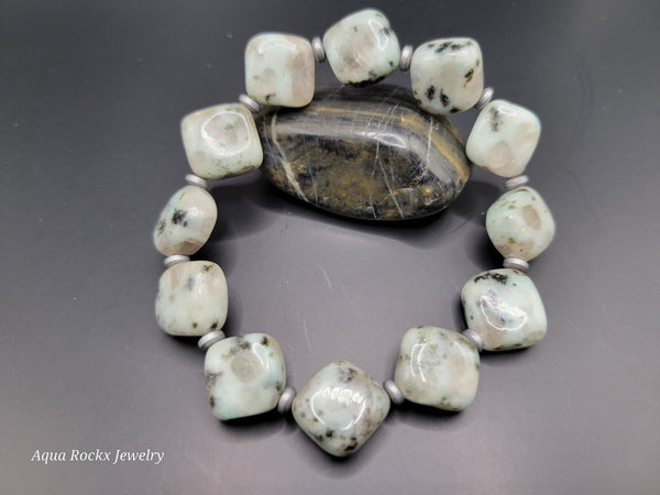 Bracelet with large stones on a gray background