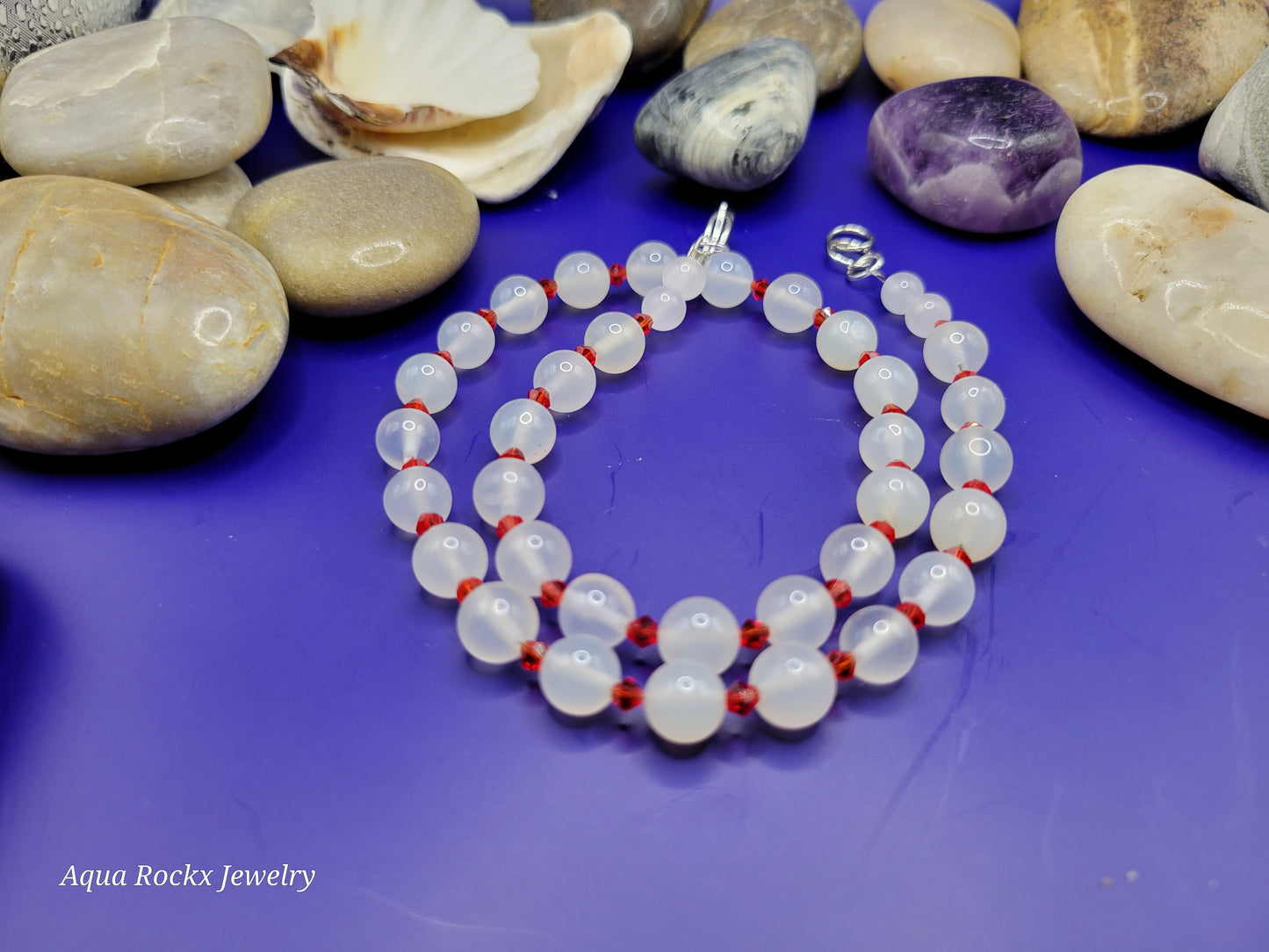 Necklace with white beads and red accents.